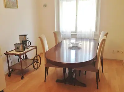 a dining room table with chairs and a coffee maker at Large Apartment sleeps up to 10 M4A in Prague