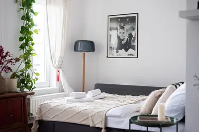 a bedroom with a bed and a window at Charming Prague Apartment in Vrovice with Roof Terrace in Prague