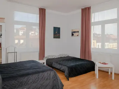 a bedroom with two beds and a large window at Comfortable apartment in Prague 8 - Libeň in Prague