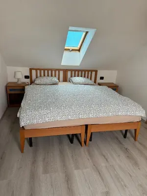 a bedroom with a large bed with a window at Cool Duplex with terrace near Florenc in Prague