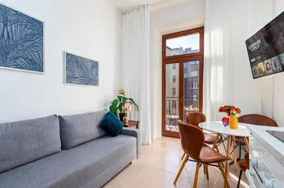 a living room with a couch and a table at Central Cozy Gateway in Prague