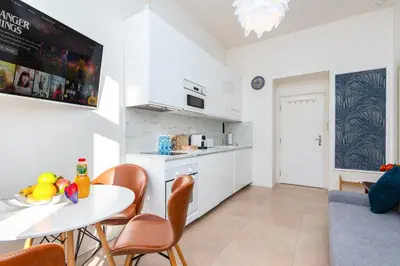 a kitchen and dining room with a table and chairs at Central Cozy Gateway in Prague