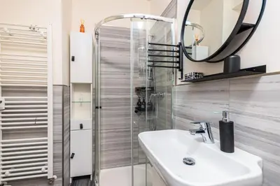a bathroom with a sink and a shower at Central Cozy Gateway in Prague