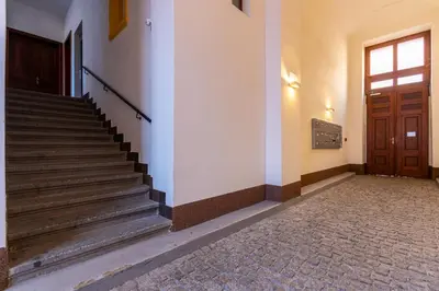 a staircase in a building with a wooden door at Central Cozy Gateway in Prague