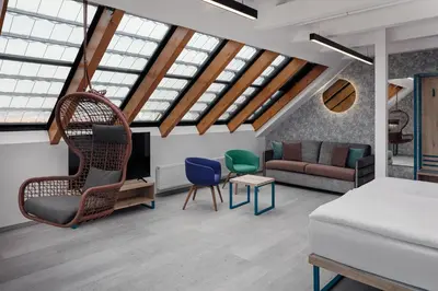 a living room with a bed and a couch at EA Hotel Moment Self Check-In in Prague