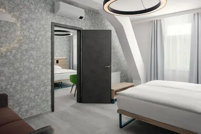 a bedroom with a bed and a door to a room at EA Hotel Moment Self Check-In in Prague