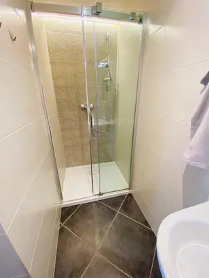 a shower with a glass door in a bathroom at Modern Apartments Letna in Prague
