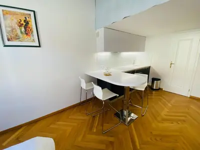 a kitchen with a white table and chairs in a room at Modern Apartments Letna in Prague