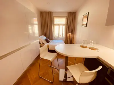 a small room with a white table and chairs at Modern Apartments Letna in Prague