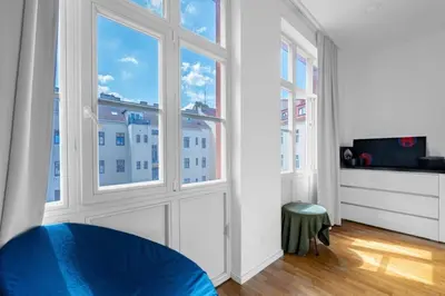 a room with a large window with a view of a building at Great apartment in the hype neighborhood in Prague