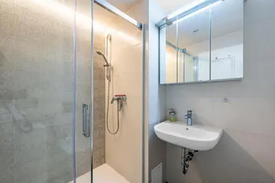 a bathroom with a shower and a sink and a mirror at Great apartment in the hype neighborhood in Prague