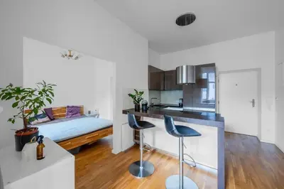 a kitchen with a counter and two stools in a room at Great apartment in the hype neighborhood in Prague