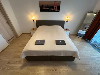 a bedroom with a bed and a large window at Garden Towers Residence - Underground Parking in Prague