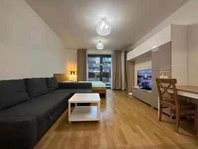 a living room with a flat screen tv at Garden Towers Residence - Underground Parking in Prague