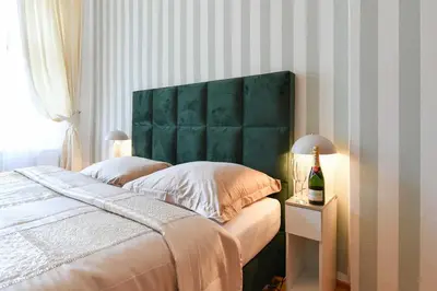 a bedroom with a bed with a blue headboard at Vinohrady Retreat 2BDR Central in Prague