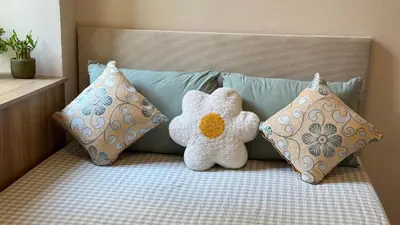 a teddy bear sitting on a bed with pillows at Newly renovated apartment in Wenceslas square in Prague