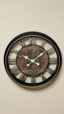 a brown and black clock on a wall at Newly renovated apartment in Wenceslas square in Prague
