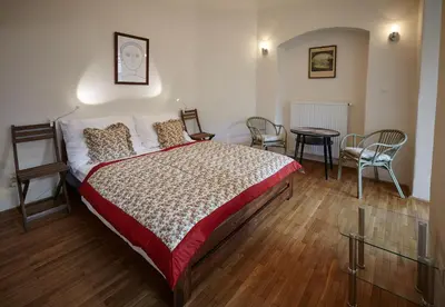 a bedroom with a bed and a table and chairs at Queen Bee apartments in Prague