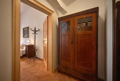 a wooden door in a hallway with a bedroom at Queen Bee apartments in Prague