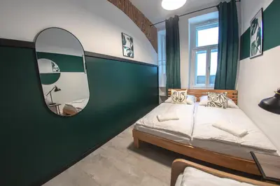 a bedroom with a bed and a mirror at Riverside Hideout in Prague