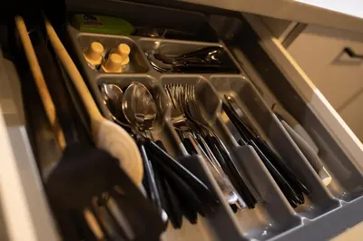 a drawer filled with utensils in a kitchen at Riverside Hideout in Prague
