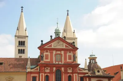 a building with two towers and a clock on it at Riverside Hideout in Prague