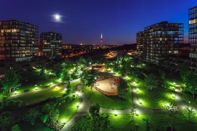 a park with lights in a city at night at Prostorný byt 3kk s krásnou terasou a vnitřním parkem in Prague