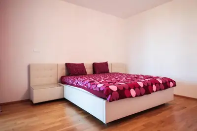 a bedroom with a bed with a pink comforter at Prostorný byt 3kk s krásnou terasou a vnitřním parkem in Prague