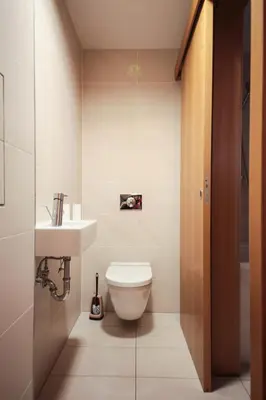 a bathroom with a toilet and a sink at Prostorný byt 3kk s krásnou terasou a vnitřním parkem in Prague