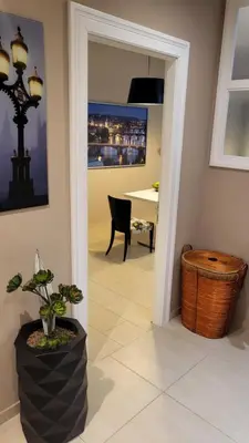 a hallway with a room with a table and a plant at Premium Apt - Free Massages from Physiotherapists in Prague