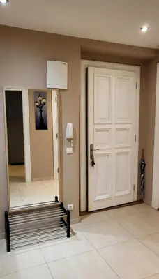 a room with a white door and a mirror at Premium Apt - Free Massages from Physiotherapists in Prague