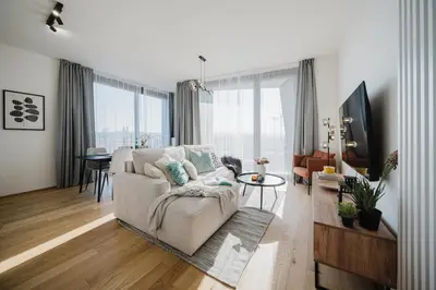 a living room with a couch and a table at Prague Days - Apartments with Garage and Balcony Near City Center in Prague