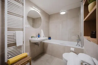 a bathroom with a sink and a bath tub at Prague Days - Apartments with Garage and Balcony Near City Center in Prague