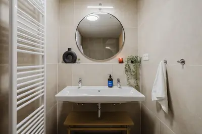 a bathroom with a sink and a mirror at Prague Days - Apartments with Garage and Balcony Near City Center in Prague