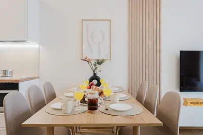 a dining room with a wooden table and chairs at Prague Days - Apartments with Garage and Balcony Near City Center in Prague