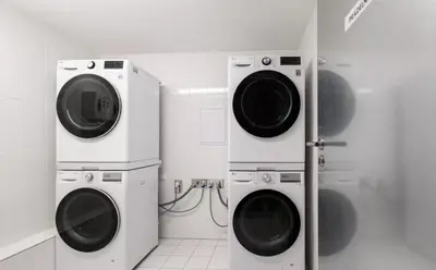 two washing machines in a bathroom next to each other at Quiet Warm studio, 5 min to Metro A, airport link, fast Wi-Fi in Prague
