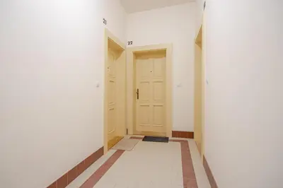 an empty hallway with two doors and a tile floor at Quiet Warm studio, 5 min to Metro A, airport link, fast Wi-Fi in Prague
