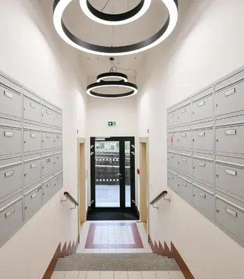 a room with lockers and a hallway with a door at Quiet Warm studio, 5 min to Metro A, airport link, fast Wi-Fi in Prague