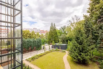 a view of a garden from a building at Quiet Warm studio, 5 min to Metro A, airport link, fast Wi-Fi in Prague