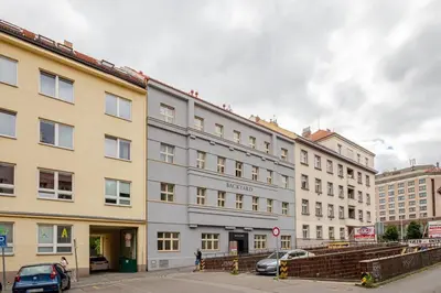 a row of buildings with cars parked in front of them at Quiet Warm studio, 5 min to Metro A, airport link, fast Wi-Fi in Prague