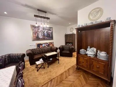 a living room with leather couches and a tv at Luxe-Boutique Apartments in Prague