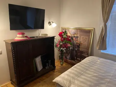 a living room with a tv on top of a cabinet at Luxe-Boutique Apartments in Prague