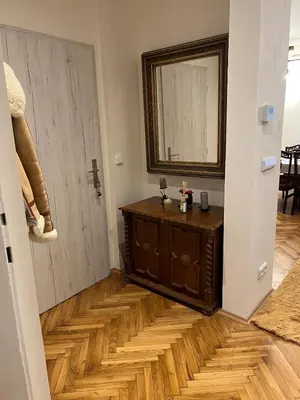 a hallway with a mirror and a wooden floor at Luxe-Boutique Apartments in Prague