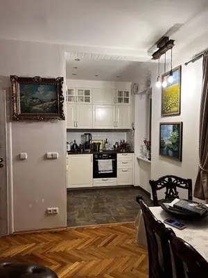 a kitchen with white cabinets and a table with a table sidx sidx at Luxe-Boutique Apartments in Prague
