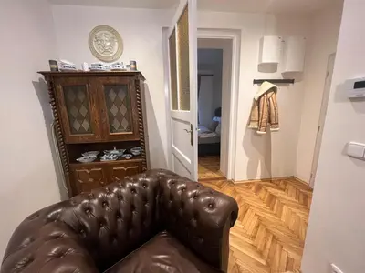 a living room with a brown leather couch in a room at Luxe-Boutique Apartments in Prague