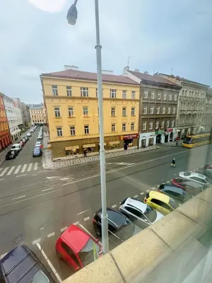 a city street with cars parked in a parking lot at Cozy Nest Home in Prague