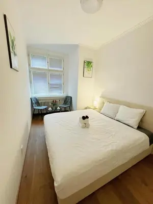 a bedroom with a large white bed with a bowl on it at Cozy Nest Home in Prague