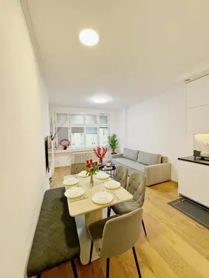 a living room with a table and chairs and a couch at Cozy Nest Home in Prague
