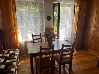 a dining room table with chairs and a vase of flowers at Chalupa Na Vyhlídce in Sudoměř