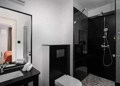 a bathroom with a shower and a toilet and a sink at The Bridge Residence by Little King in Prague